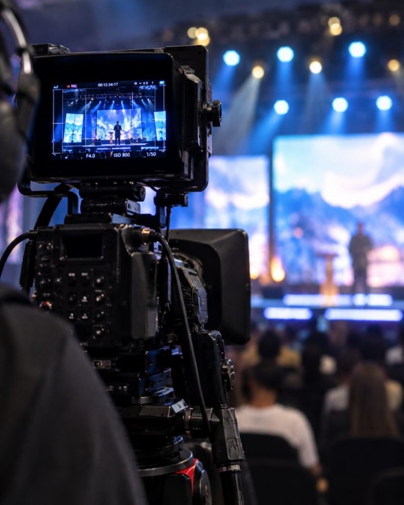 Close-up of a video camera filming a stage