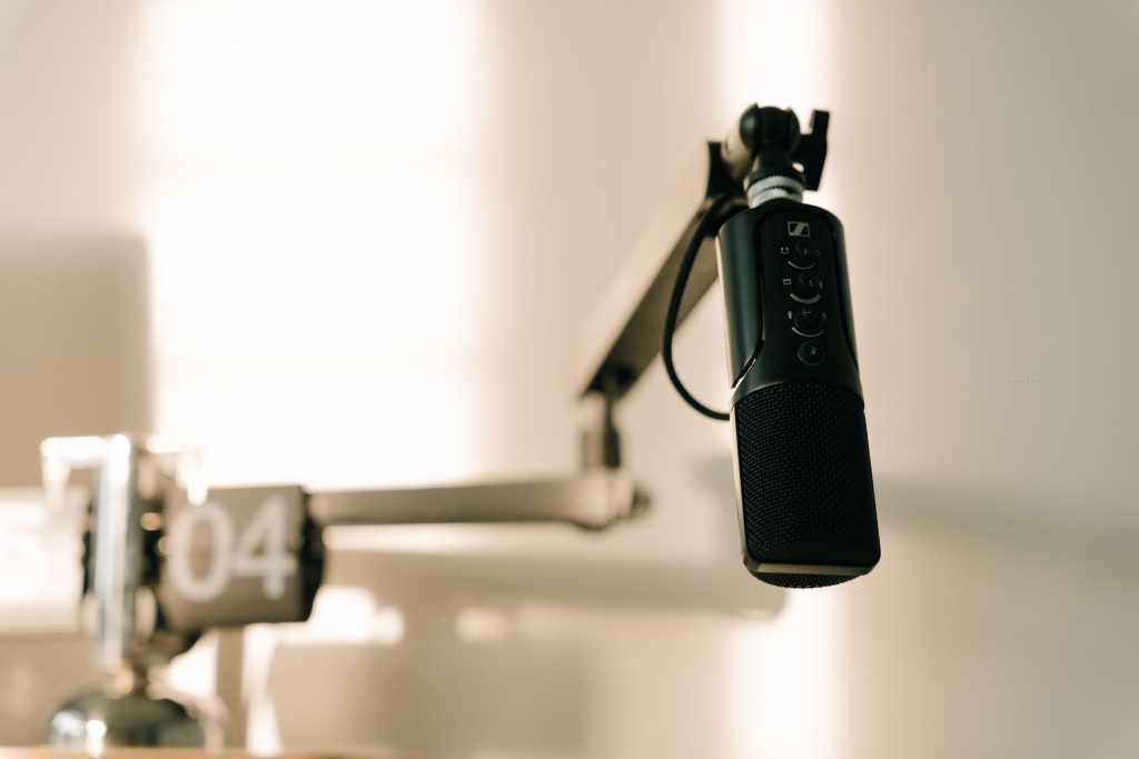 Professional microphone on a boom arm in a minimalist recording space