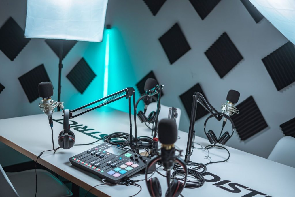 Podcast recording setup with microphones, audio mixer and acoustic panels