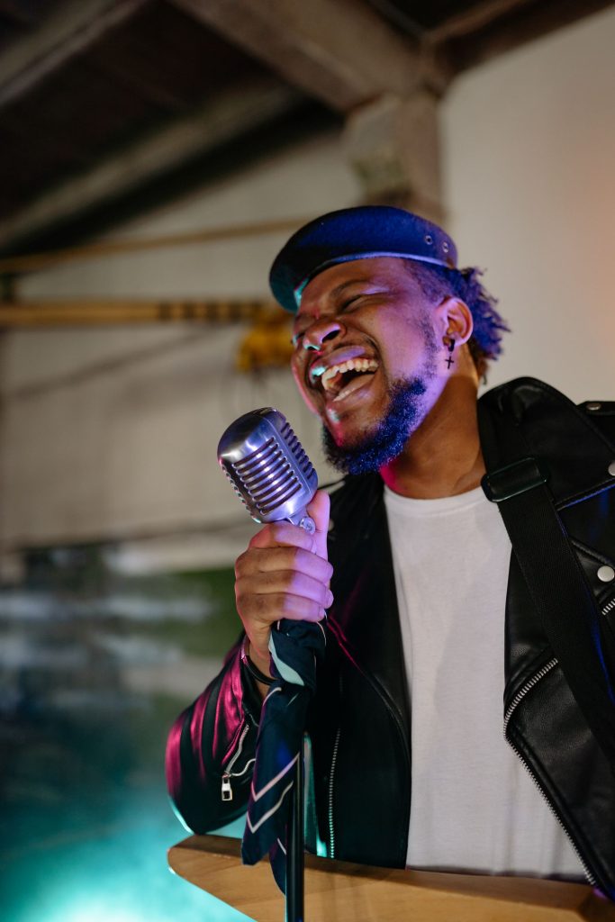 Singer performing into a vintage microphone during a voice recording