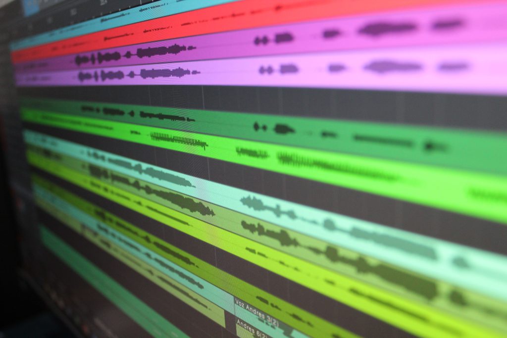 Close-up of colourful audio waveforms displayed on a screen