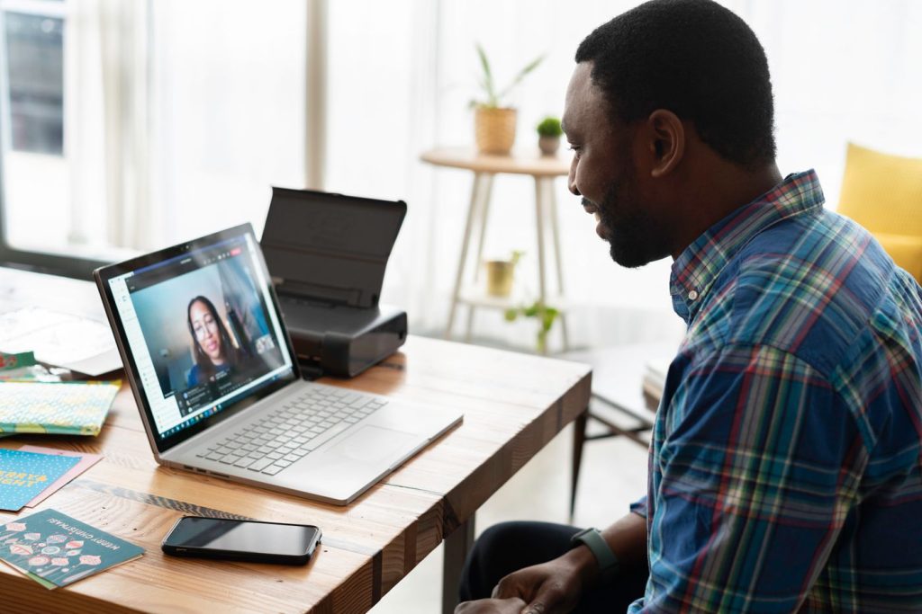 Professional participating in a Zoom livestream meeting from a laptop