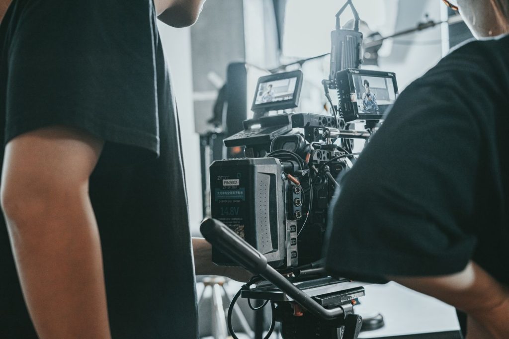 Production crew operating professional camera equipment for a livestream