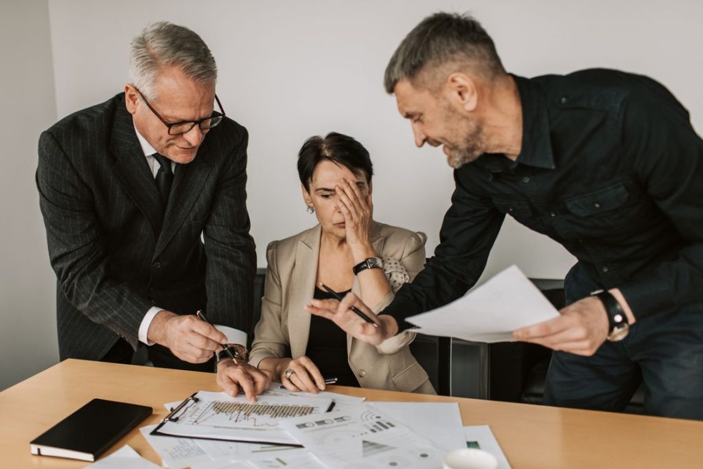Business team analyzing charts and performance data at an office desk